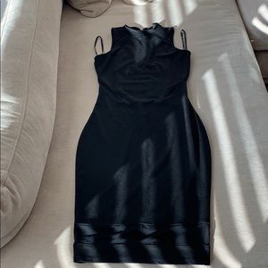 Black bodycon dress with cutouts.